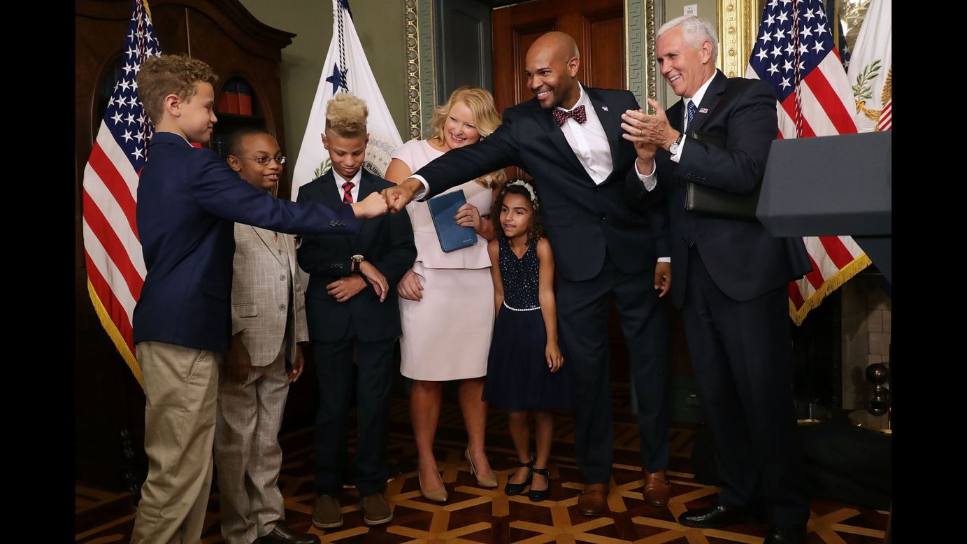 Dr. Jerome Adams, <a href="http://www.cnn.com/2017/08/04/health/jerome-adams-surgeon-general-confirmation/index.html" target="_blank">the new surgeon general</a> of the United States, fist-bumps one of his sons after being sworn in by Vice President Mike Pence on Tuesday, September 5.