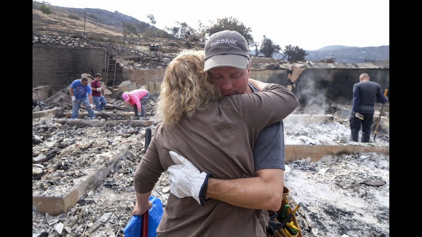 Craig Bolleson hugs a friend in his burned-out home in Los Angeles on Monday, September 4. A day earlier, the La Tuna brush fire caused Gov. Jerry Brown <a href="http://www.cnn.com/2017/09/02/us/los-angeles-wildfire/index.html" target="_blank">to issue a state of emergency</a> for Los Angeles County.