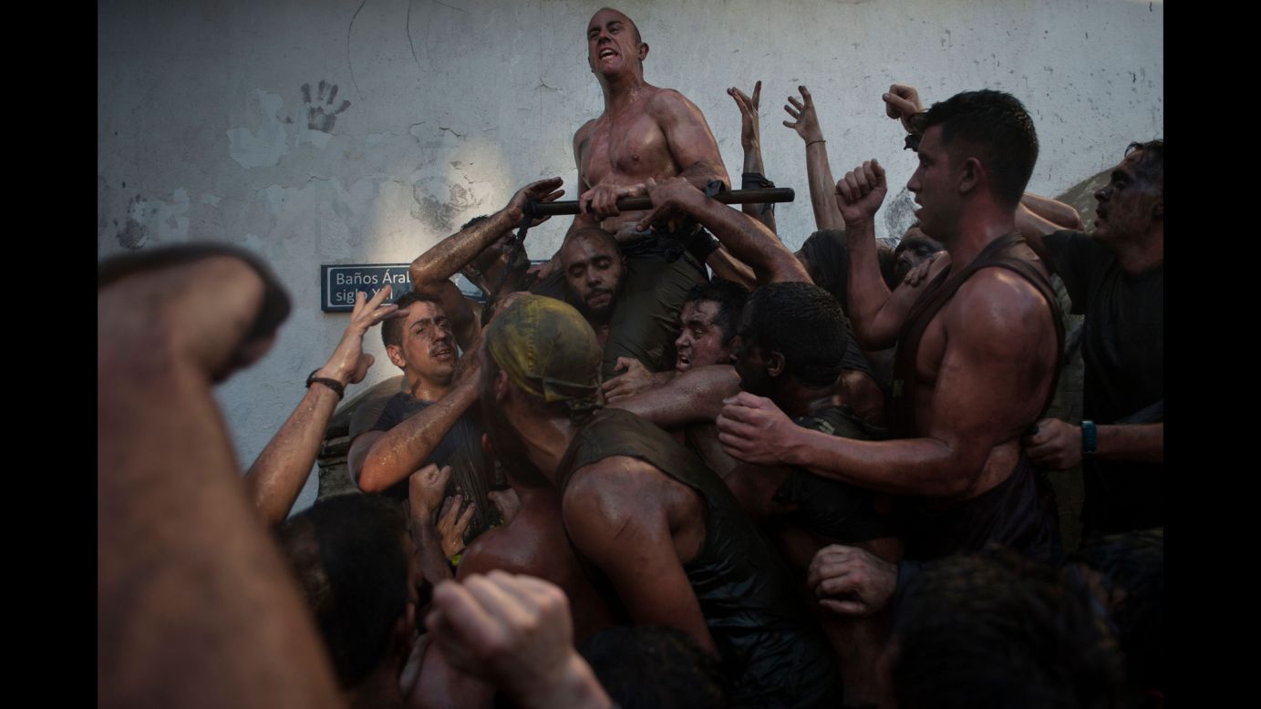 People covered in black grease climb on one another Wednesday, September 6, during the Cascamorras festival in Baza, Spain.