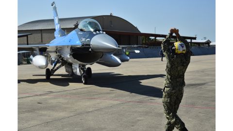 A sailor marshals an F-16 Fighting Falcon from Florida on September 6 at Naval Air Station Fort Worth Joint Reserve Base, Texas.