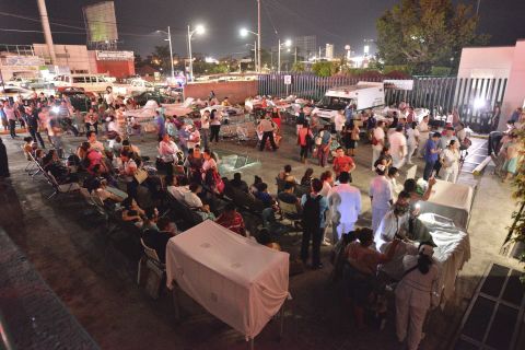 Medical staff and patients wait outside after a hospital was evacuated in Villahermosa, Mexico.