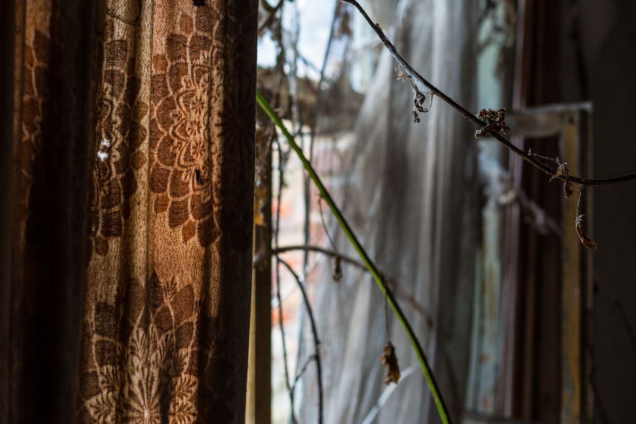 <strong>Abandoned Berlin -- abandoned house:</strong> In many of Fahey's photographs, nature is taking over humankind's forgotten relics. Here, curtains mingle with brambles in the windows of an abandoned house.