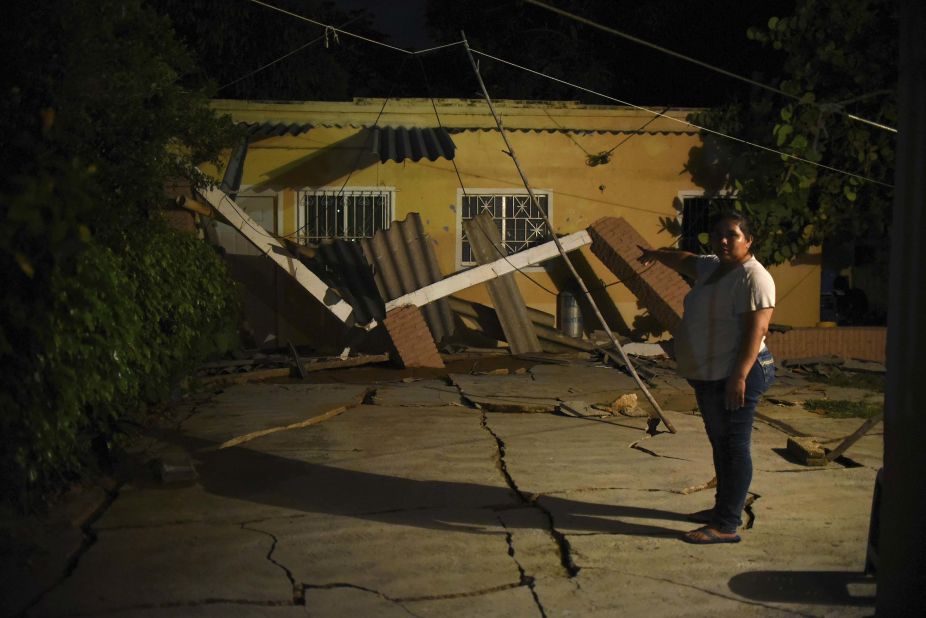 A woman gestures toward her earthquake-damaged home in Coatzacoalcos, Mexico.