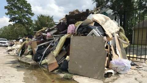 Debris from flooded homes is piled outside in Lakewood near the home of Daniela Alvarado and Leonardo Aguirre.