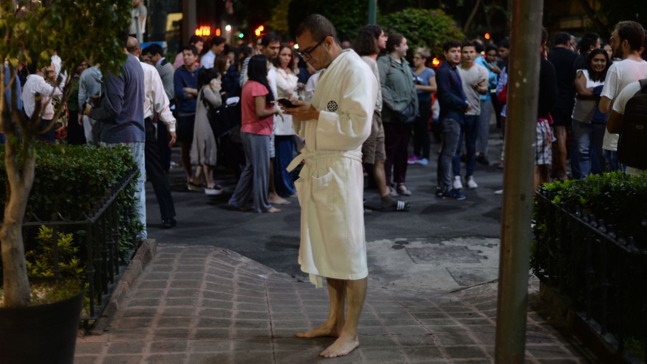 People gather on a street in downtown Mexico City during the quake.