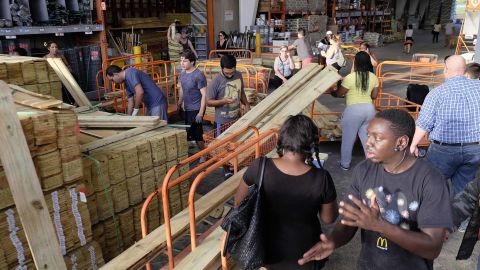 People buy wood to secure their property in anticipation of Hurricane Irma early Friday, in Miami, Florida.