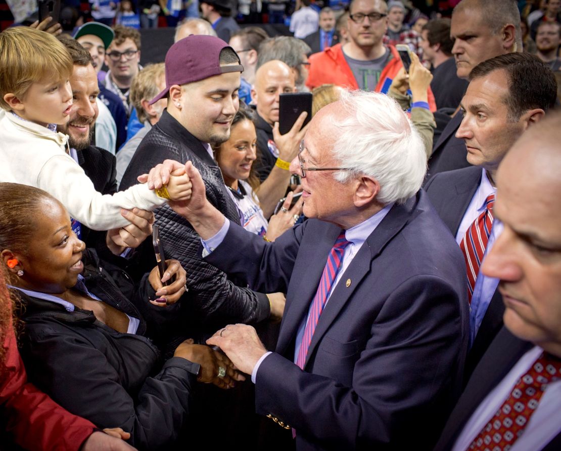 Vitali Shkliarov and his son, Nikita, shake hands with Bernie Sanders on the campaign trail.