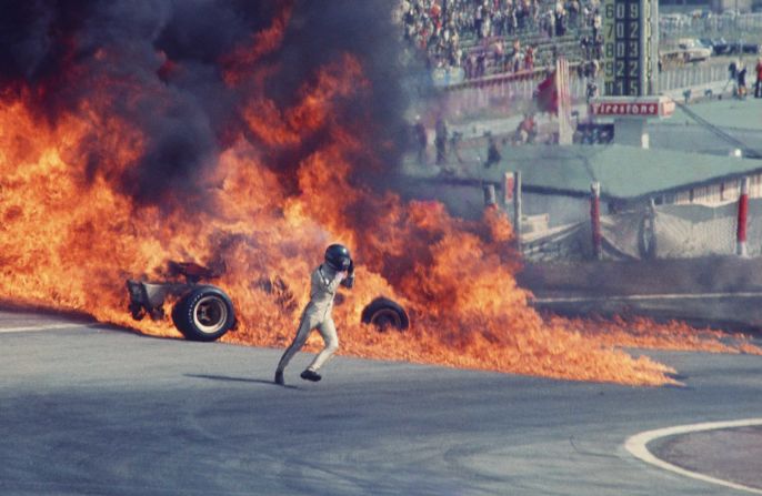 Joe Honda photographed Jacky Ickx against a wall of fire as the Belgian escaped from his burning race car at the Jarama circuit, Spain 1970.