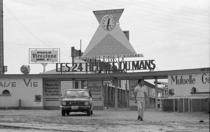 Joe Honda walks beside his Toyota Corolla car outside of the Le Mans Grand Prix