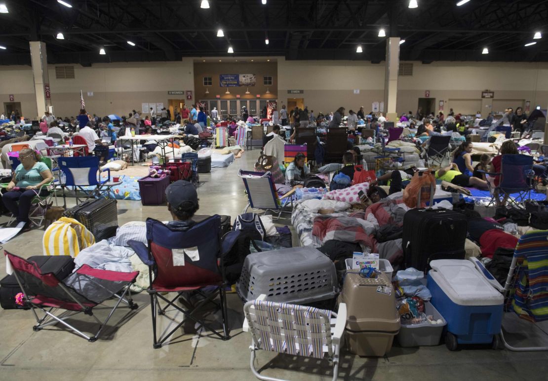 People settle into a shelter in Miami on Friday.
