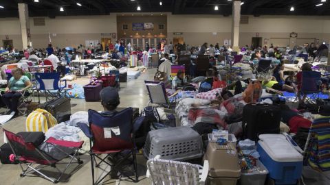 People settle into a shelter in Miami on Friday.