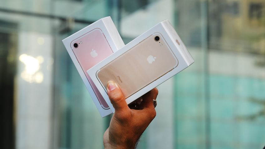 NEW YORK, NY - SEPTEMBER 16:  One of the first customers to buy a new iPhone walks out of an Apple store in Manhattan on September 16, 2016 in New York City. People around the globe waited in long lines to be among the first to purchase both the iPhone 7 and the iPhone 7 Plus. The phones offer longer battery life, faster browsing, a better camera and do not have a traditional headphone jack.  (Photo by Spencer Platt/Getty Images)