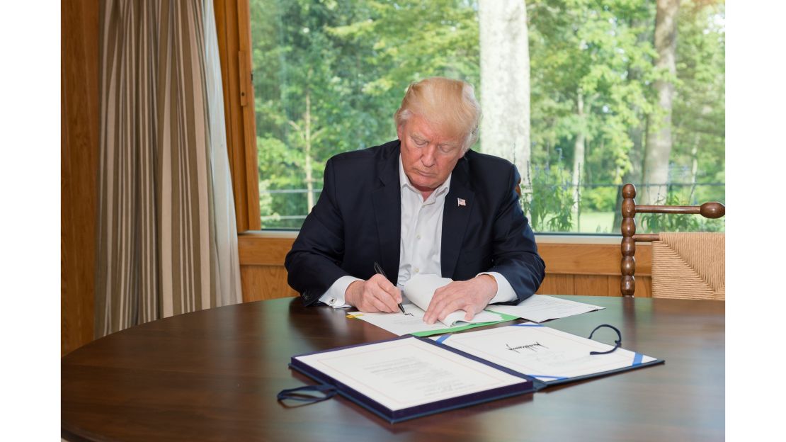 President Trump signs a $15 billion Hurricane Harvey relief bill on September 8 at Camp David.