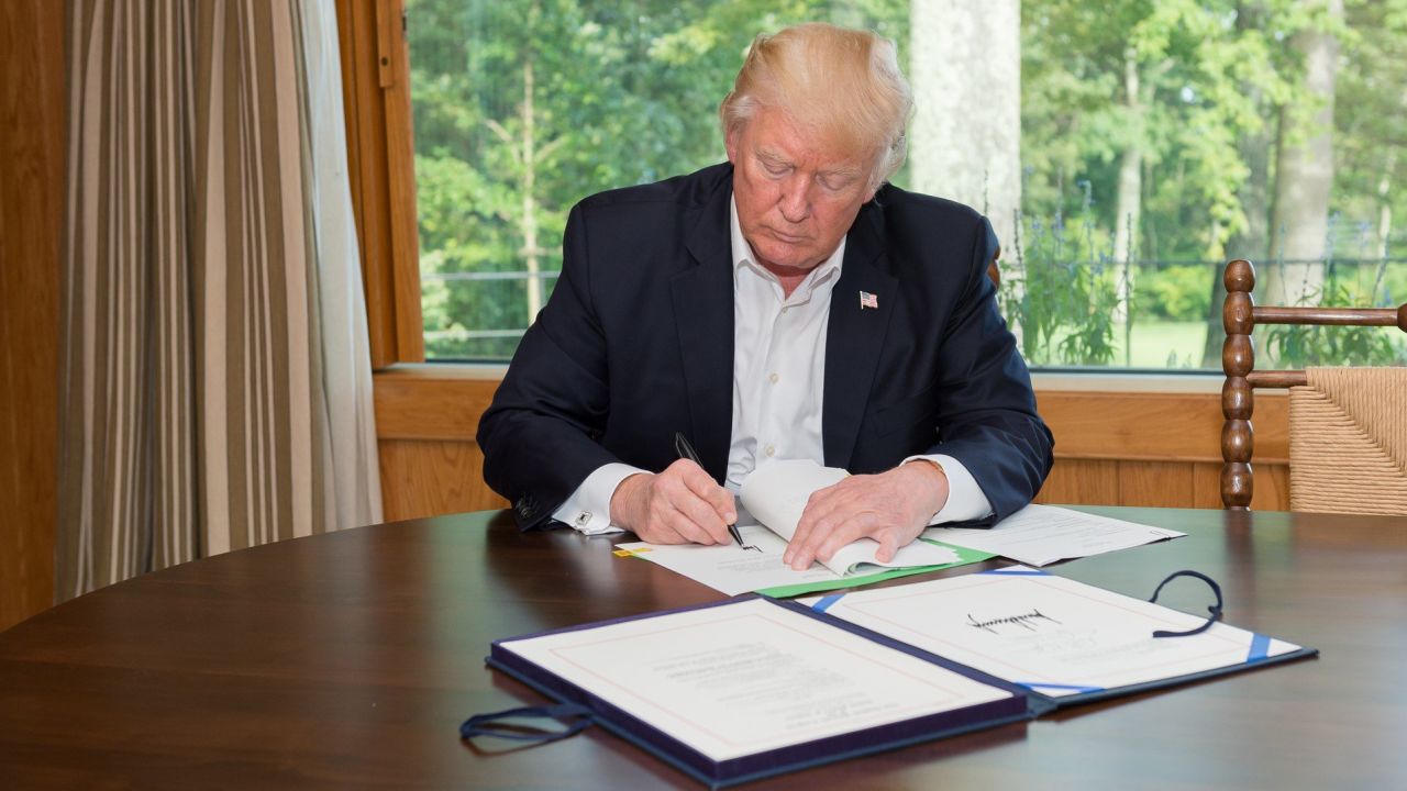President Trump signs a $15 billion Hurricane Harvey relief bill on September 8 at Camp David.