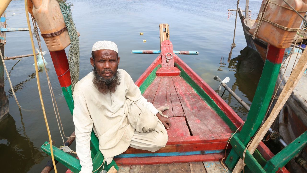 Fisherman Mohammad Rasheed, 41, sits aboard a boat in southeastern Karachi.