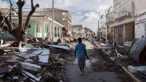 A man walks up a street Friday on the island of St. Martin.