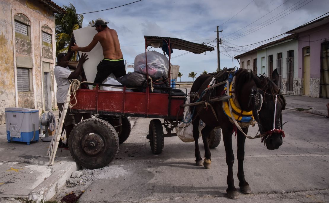 Men in Caibarien, Cuba, prepare Friday for the storm.