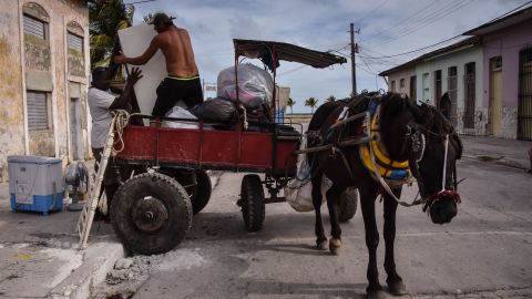 Men in Caibarien, Cuba, prepare Friday for the storm.