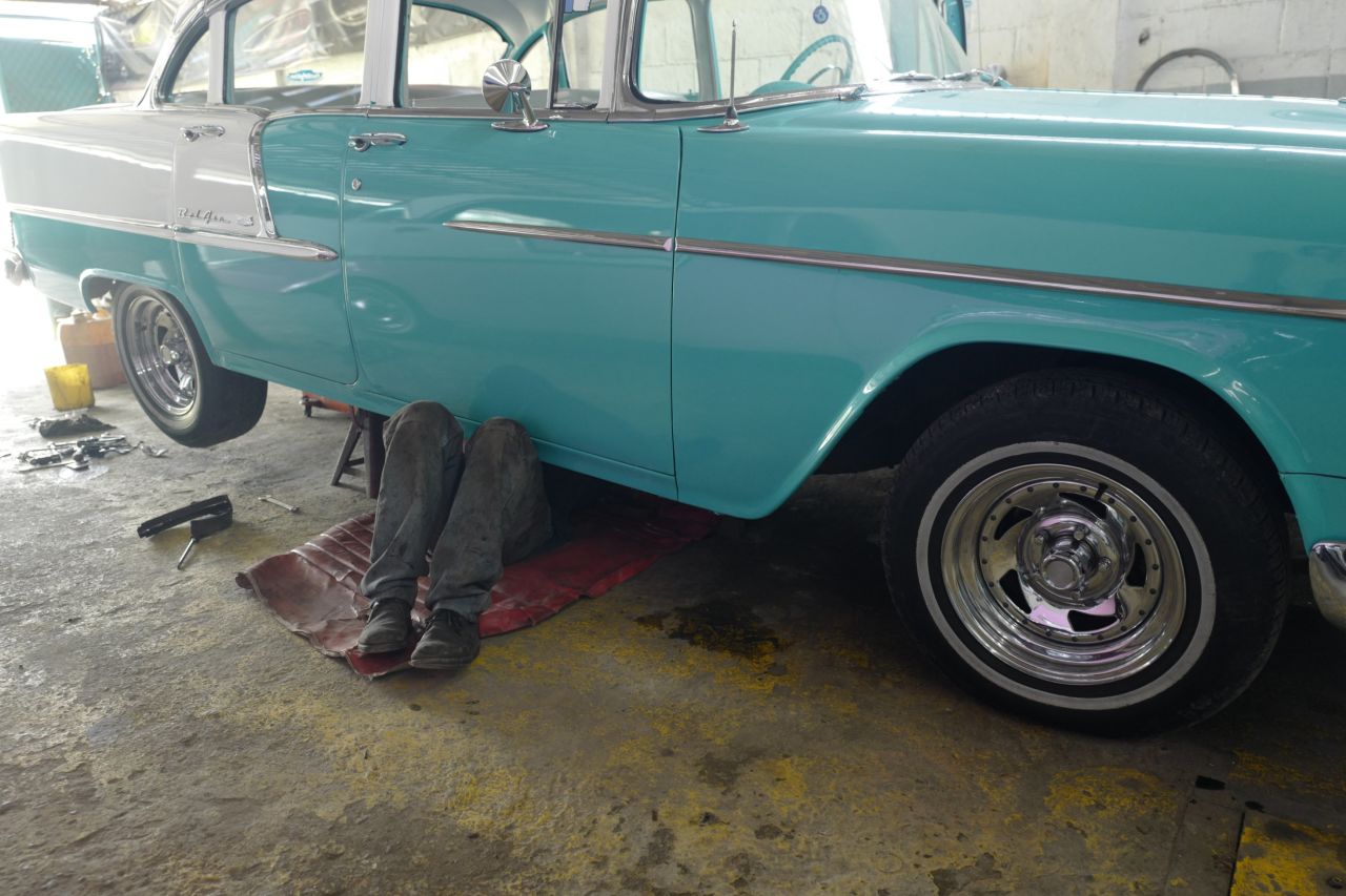 A mechanic works on a classic car in Nidialys Acosta Cabrera's garage. 