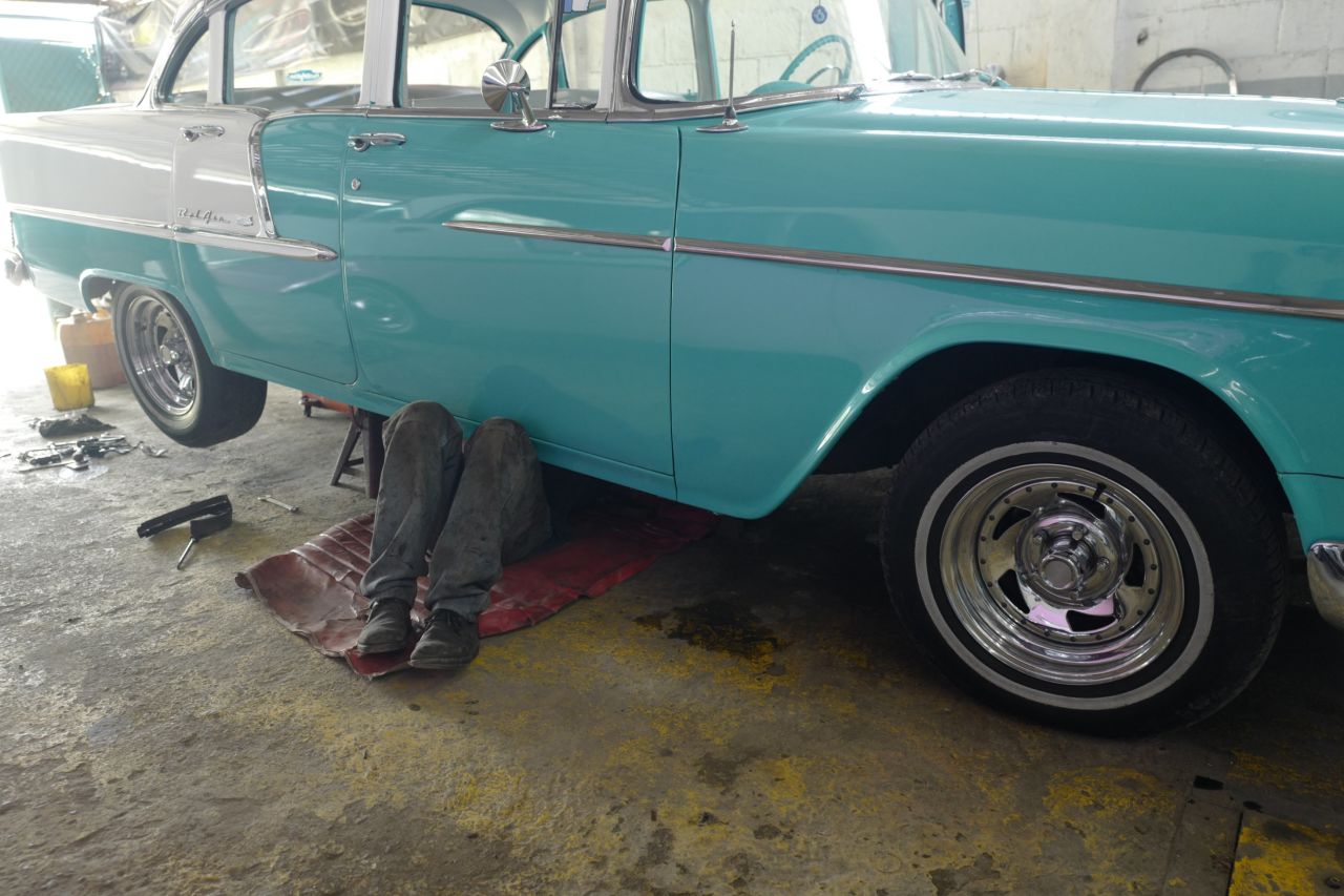 A mechanic works on a classic car in Nidialys Acosta Cabrera's garage.