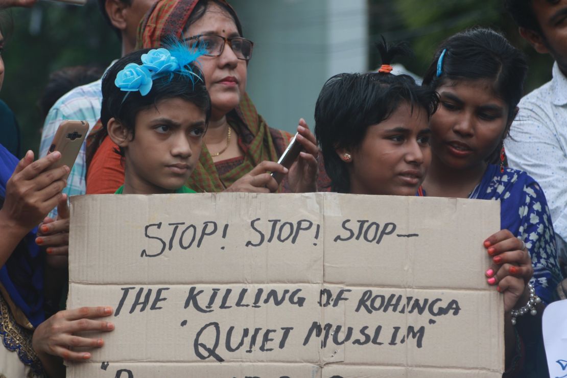 Children hold a placard calling on Myanmar to stop the killing of Rohingya Muslims, during a rally in Dhaka on September 8. 