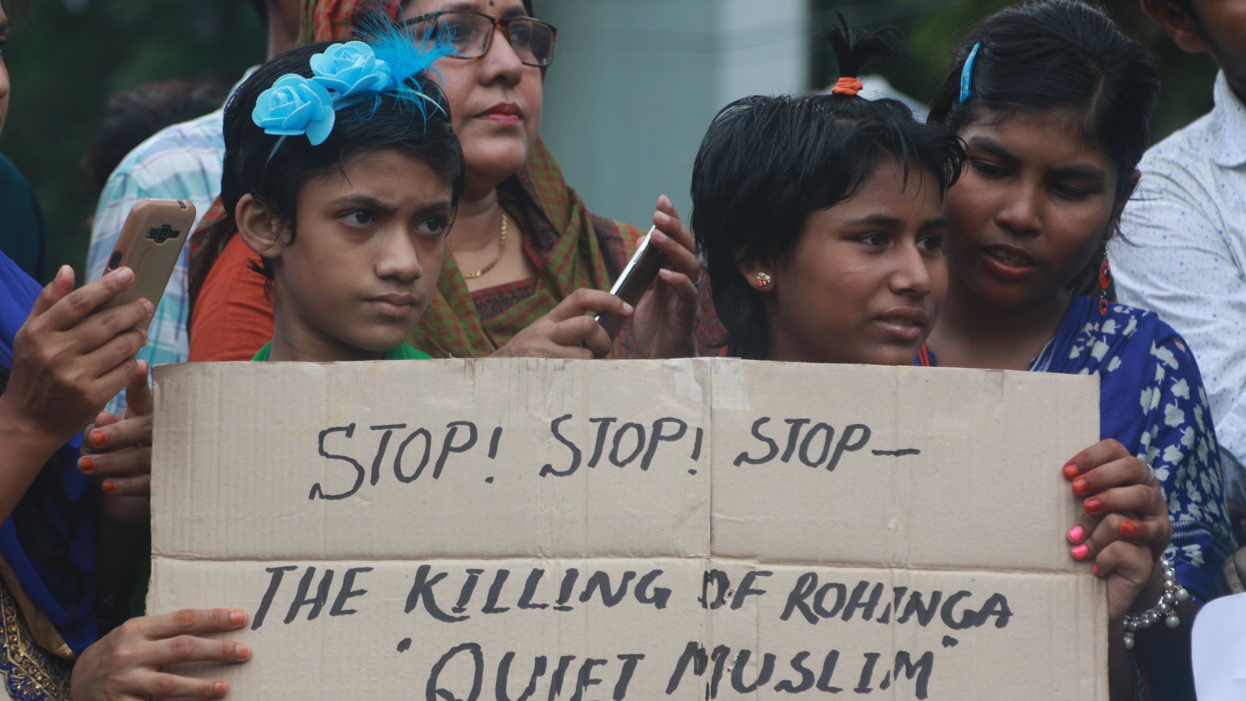 Children hold a placard calling on Myanmar to stop the killing of Rohingya Muslims, during a rally in Dhaka on September 8. 
