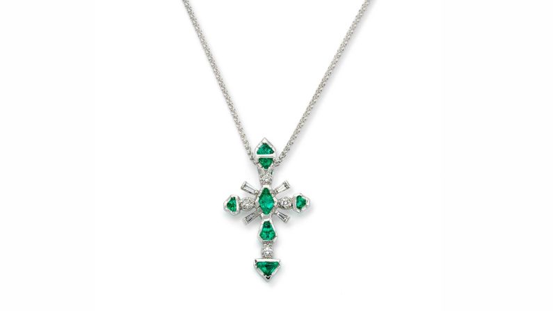 Seven kite-cut Colombian emeralds and diamonds, set in platinum, form a cross.