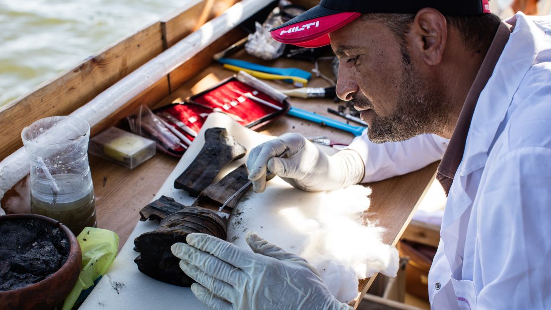 Archaeologists sift through new artifacts found in the excavation of Thonis-Heracleion aboard the Princess Duda research vessel.