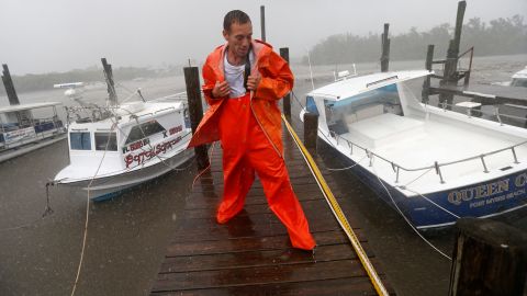 PJ Pike checks on his and his friend's boats, sitting in mud after the water was pulled away from Fort Myers on September 10.