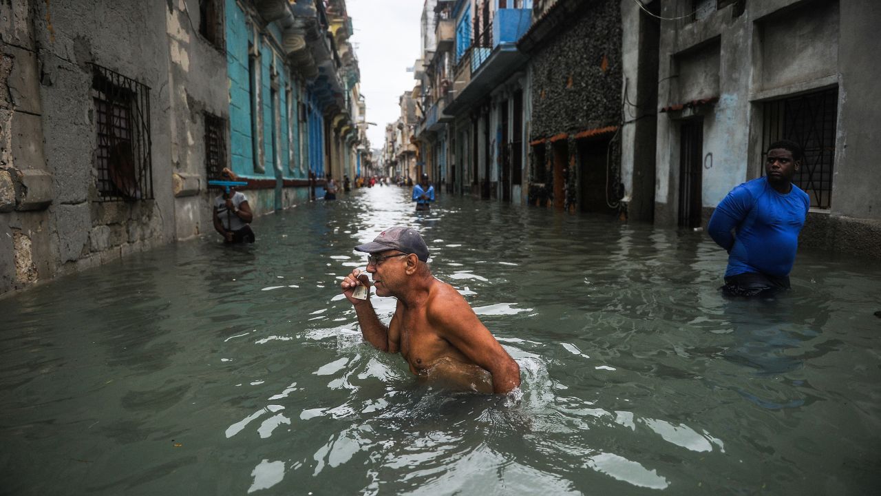 A Cuban man wades through a flooded street in Havana on September 10.