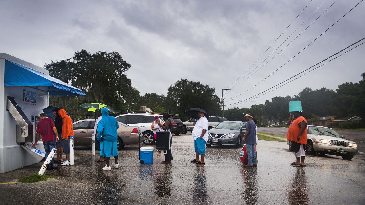 Geoff Rutland, a local volunteer from Crossing Jordan Church, helps other residents get ice from a vending machine in Tampa, Florida, on September 10.