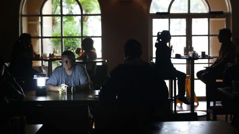 Hotel guests eat breakfast by lamplight after the Courtyard Marriott was left without power in Fort Lauderdale on September 10.