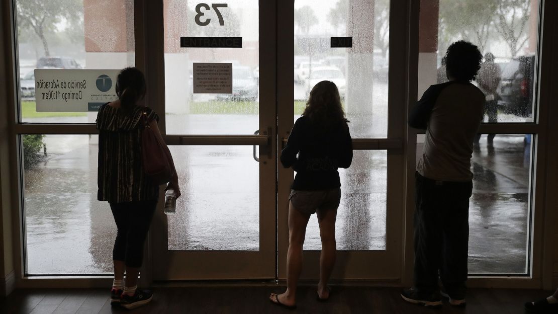 Evacuees in Naples watch from inside a shelter as Irma inches closer on September 10.
