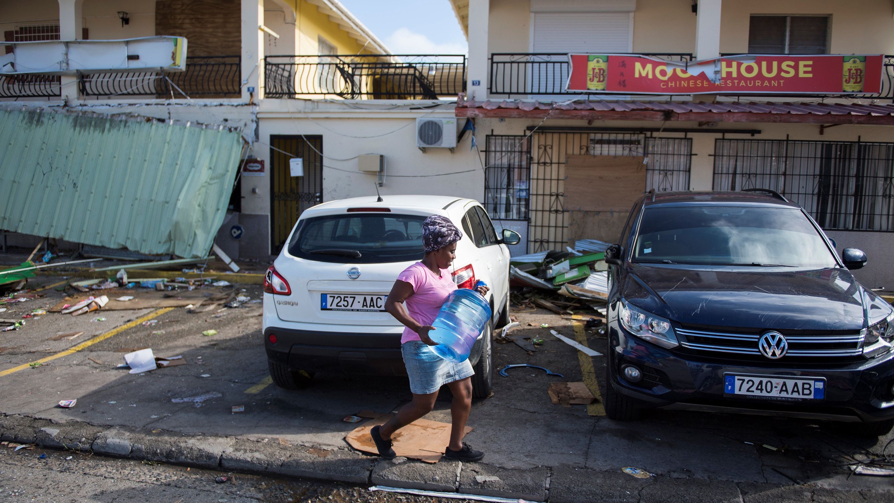 A woman carries a container of water on a street in Marigot, on the island of St. Martin, September 10.