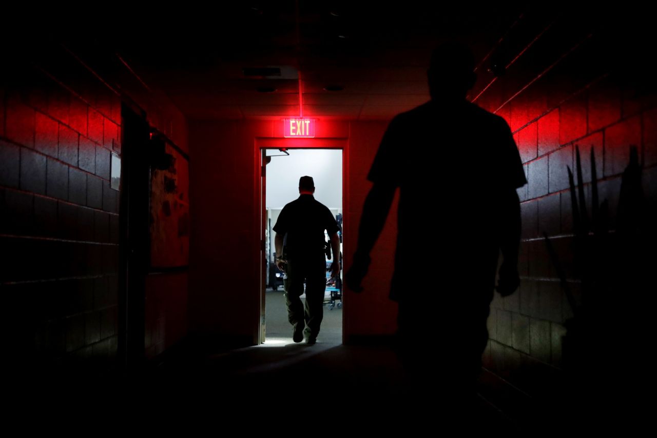 A sheriff's deputy walks through a shelter in Naples after the power went out on September 10.