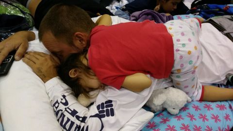 Little Mya fell asleep on her dad at a hurricane shelter in Estero.