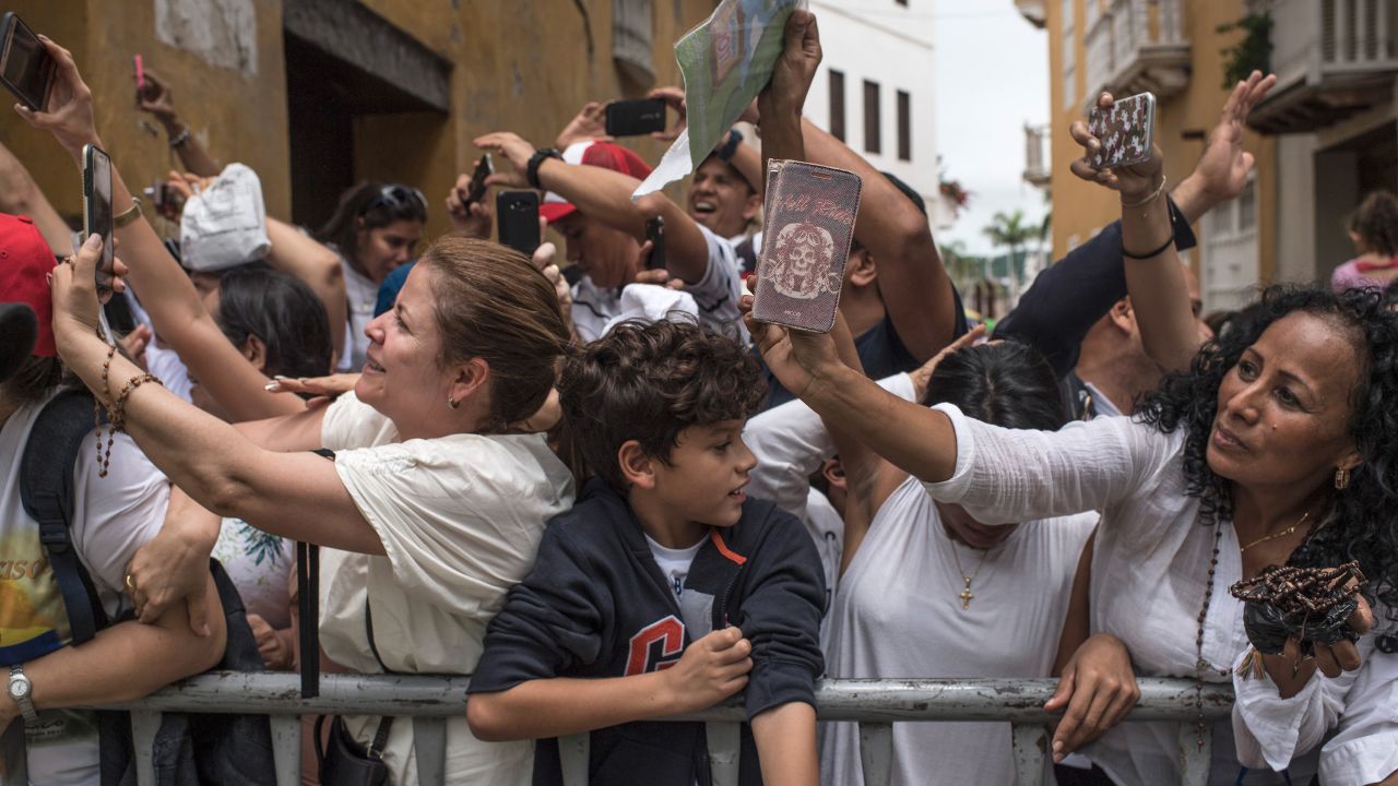 Colombian faithful take pictures of Pope Francis as he leaves San Pedro Claver church in Cartagena, Colombia on September 10, 2017.