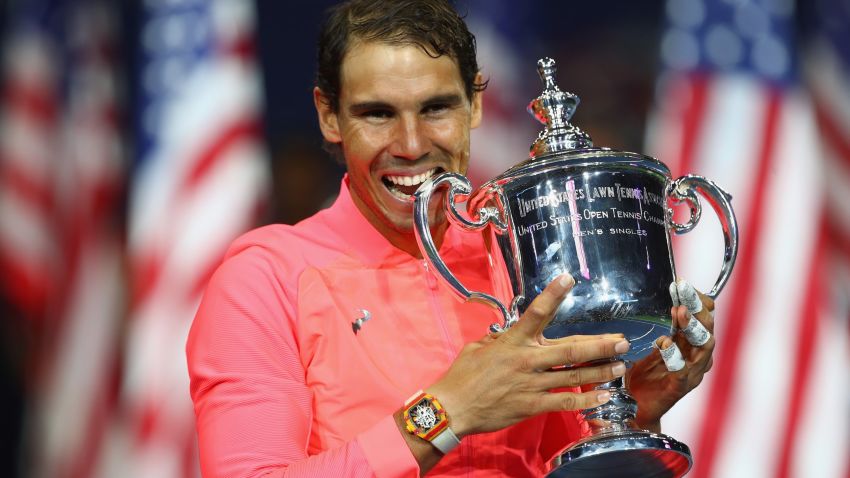 NEW YORK, NY - SEPTEMBER 10:  Rafael Nadal of Spain bites the championship trophy during the trophy ceremony after their Men's Singles Finals match on Day Fourteen of the 2017 US Open at the USTA Billie Jean King National Tennis Center on September 10, 2017 in the Flushing neighborhood of the Queens borough of New York City. Rafael Nadal defeated Kevin Anderson in the third set with a score of 6-3, 6-3, 6-4.  (Photo by Clive Brunskill/Getty Images)