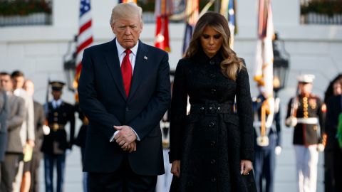 President Donald Trump and first lady Melania Trump stand at the White House for a moment of silence to mark the anniversary of the Sept. 11 terrorist attacks.