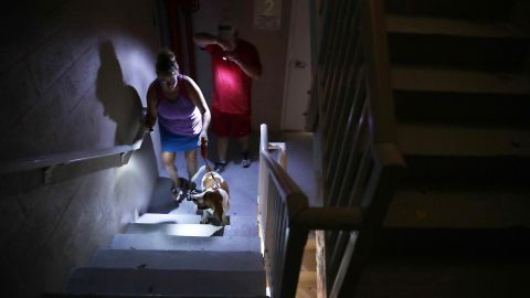 Hotel guests navigate a dark stairwell after they lost power in Fort Lauderdale, Florida.