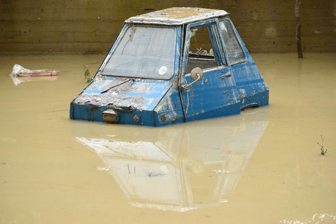 A partially submerged car in the Livorno area, flooded after heavy rain.