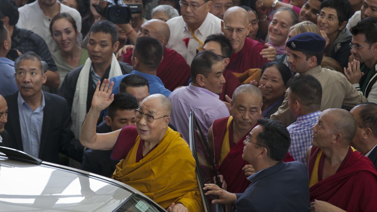 Tibetan spiritual leader the Dalai Lama greets devotees as he leaves the Tsuglakhang temple in Dharmsala, India, Friday, September 1.
