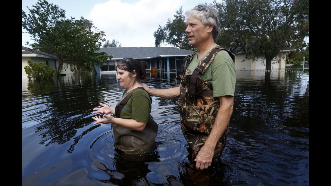 Kelly McClenthen and her boyfriend, Daniel Harrison, walk through floodwaters in Bonita Springs on September 11.