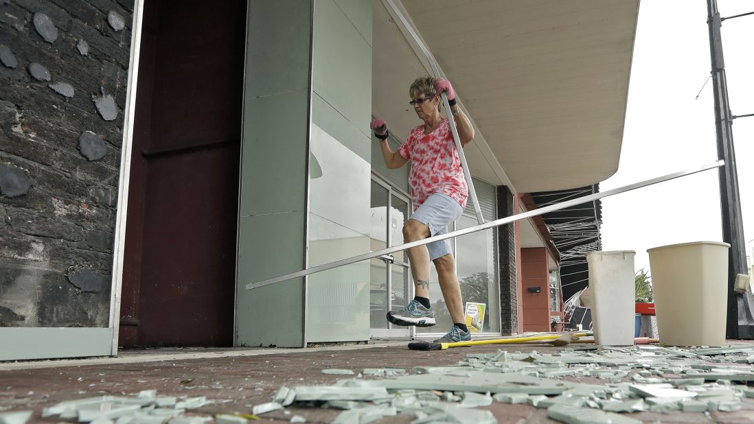 Catharine Taylor Woods cleans up a broken awning outside her building in Wauchula, Florida, on September 11.