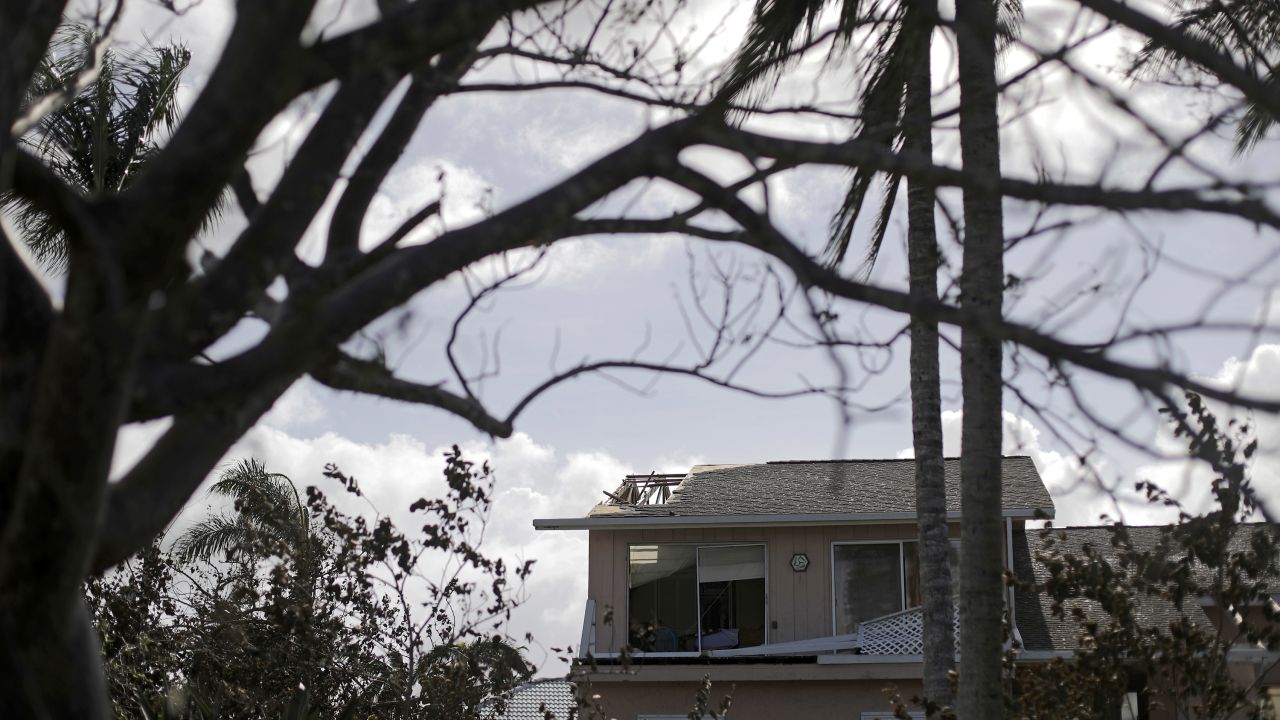 The roof of a home is damaged in Marco Island, Florida, on September 11.