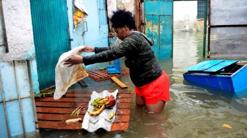 A woman tries to rescue some food from her flooded house in downtown Havana on September 10.