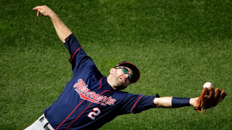 Minnesota second baseman Brian Dozier misses a fly ball during a game in Kansas City, Missouri, on Sunday, September 10.
