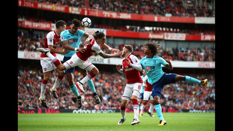 Bournemouth defender Tyrone Mings rises for a header with two Arsenal players during a Premier League match in London on Saturday, September 9.