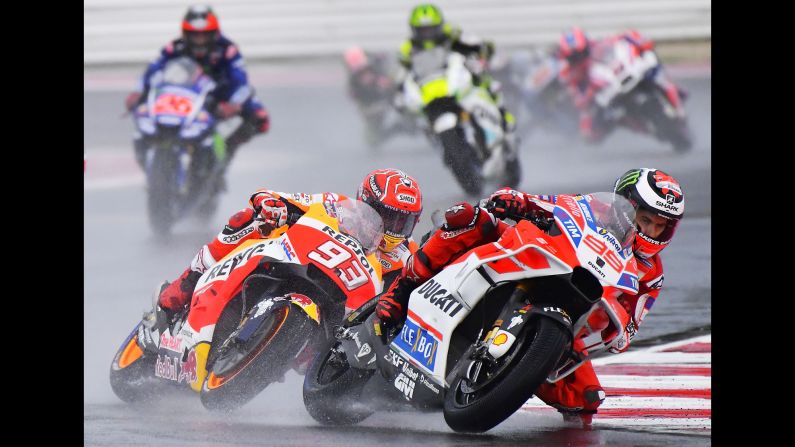 MotoGP riders Marc Marquez, left, and Jorge Lorenzo compete during the San Marino Grand Prix on Sunday, September 10. Marquez would go on to win the race. Lorenzo crashed and finished in 23rd place.