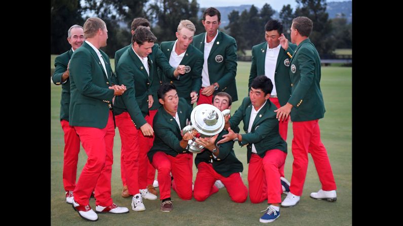 The US amateur golf team nearly drops the Walker Cup trophy after defeating Great Britain and Ireland on Sunday, September 10.